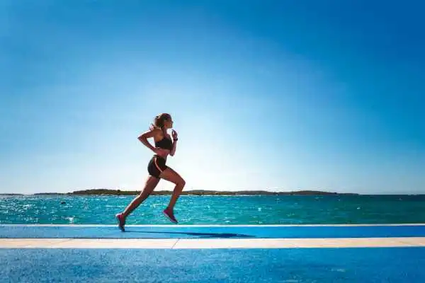 Woman running showing strong leg muscle Bridgend